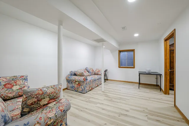 a bedroom with furniture and a wooden floor