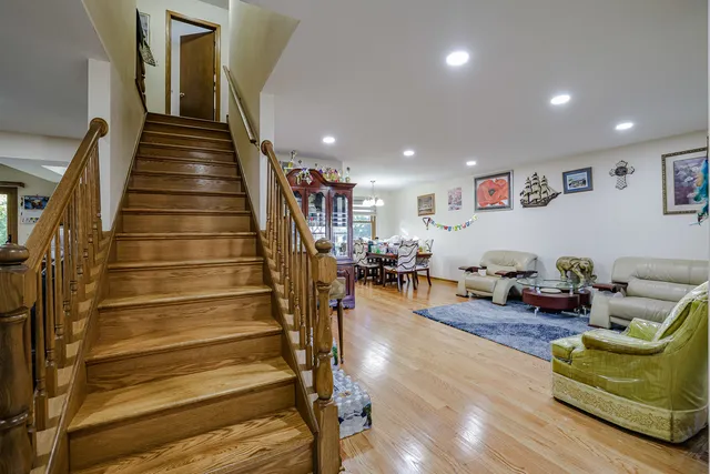a living room with furniture and stairs