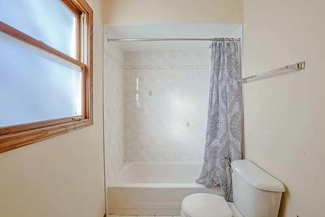 a bathroom with a shower and a toilet