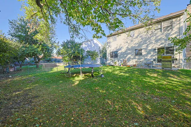 a garden with trees in front of it