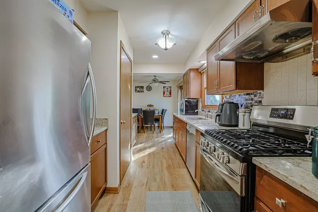 a kitchen with stainless steel appliances granite countertop a stove and a sink