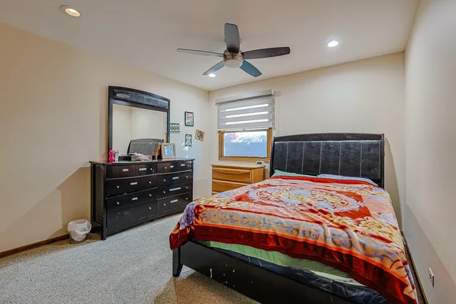 a bedroom with a bed and a dresser