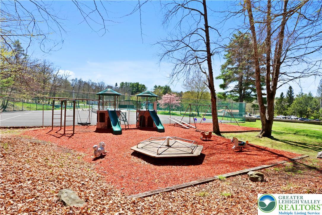 214 Mockingbird Court Bushkill, PA 18324 - Photo 39 of 40 a view of a patio with a table chairs and a fire pit