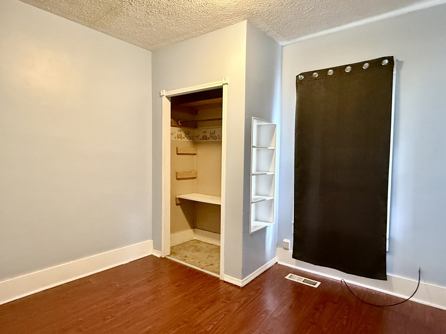 203 West 12th Street Metropolis, IL 62960 - Photo 11 of 27 an empty room with wooden floor and closet