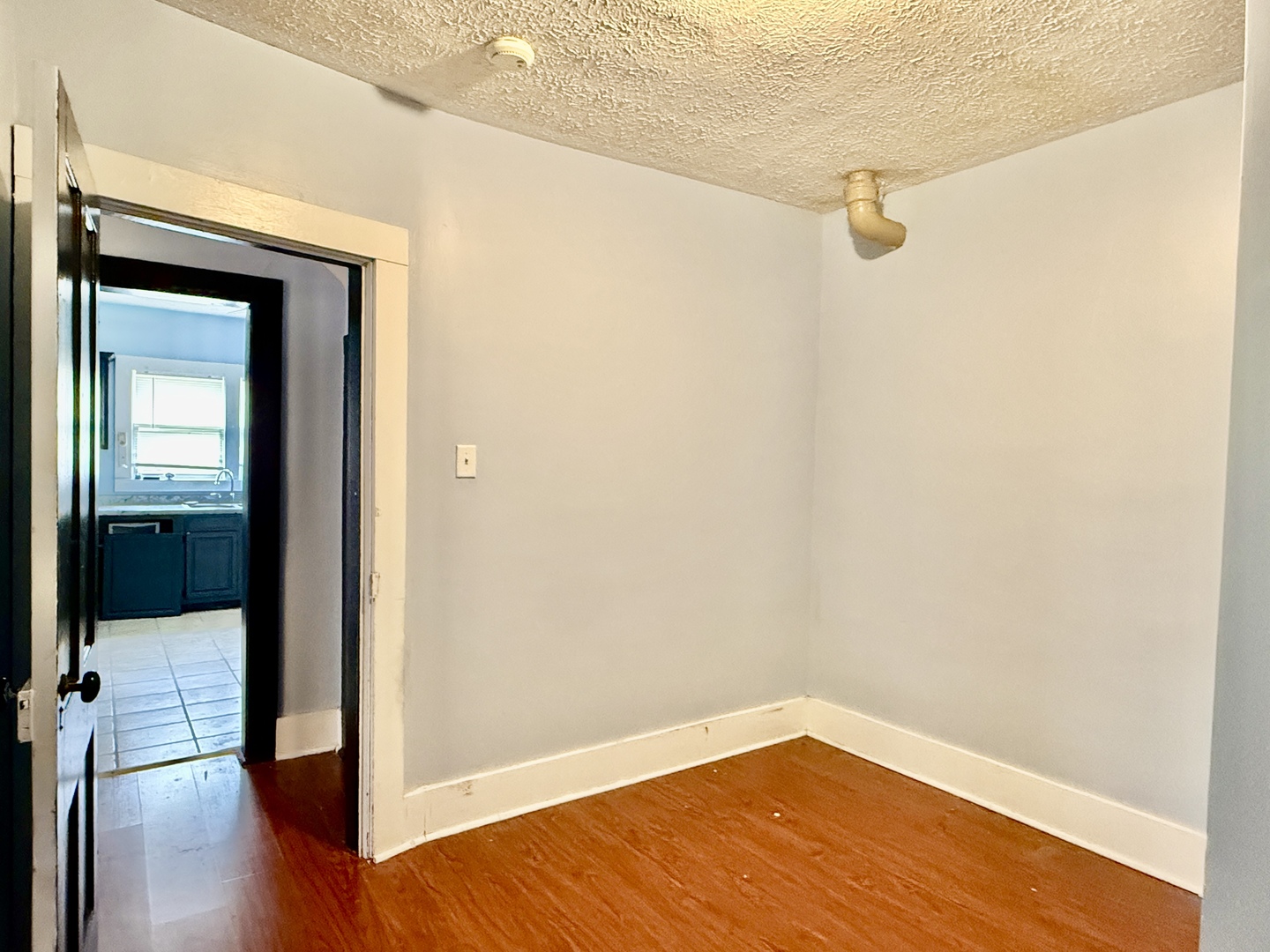 203 West 12th Street Metropolis, IL 62960 - Photo 12 of 27 a view of a room with wooden floor and a bathroom