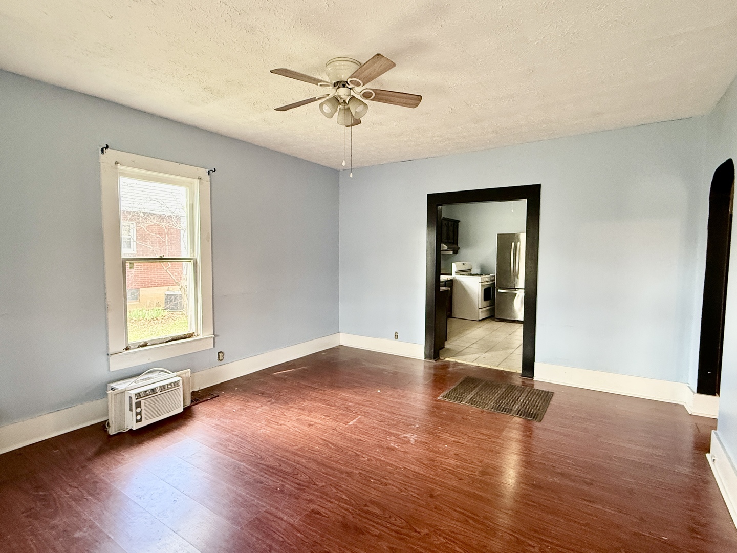 203 West 12th Street Metropolis, IL 62960 - Photo 5 of 27 an empty room with wooden floor and windows