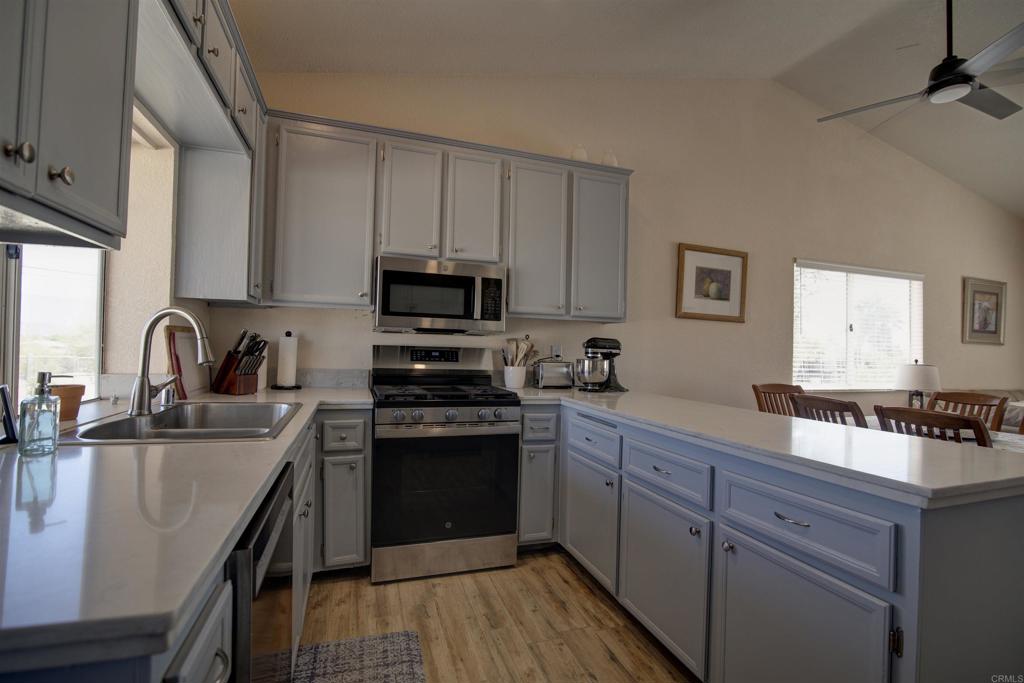 3302 Swinging V Road Borrego Springs, CA 92004 - Photo 3 of 14 a kitchen with stainless steel appliances granite countertop a sink stove and refrigerator