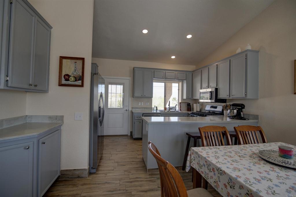 3302 Swinging V Road Borrego Springs, CA 92004 - Photo 4 of 14 a kitchen with a table chairs refrigerator and cabinets