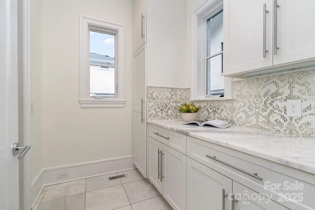 a view of a hallway with wooden floor and a living room
