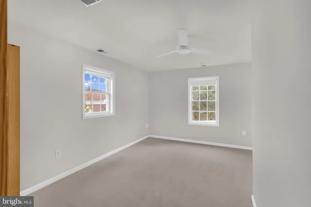 a view of a livingroom with furniture and a ceiling fan