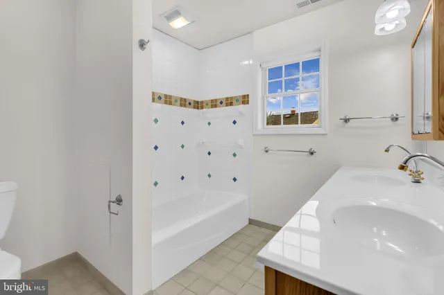 a bathroom with a sink a toilet and bathtub