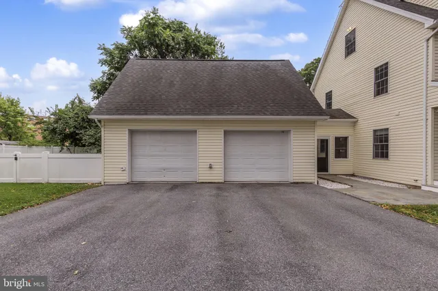 a large kitchen with kitchen island a large counter top space a sink stainless steel appliances and cabinets