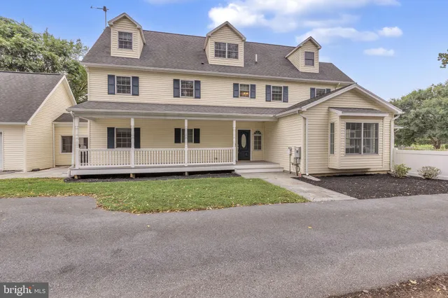 an aerial view of a house with a garden and lake view