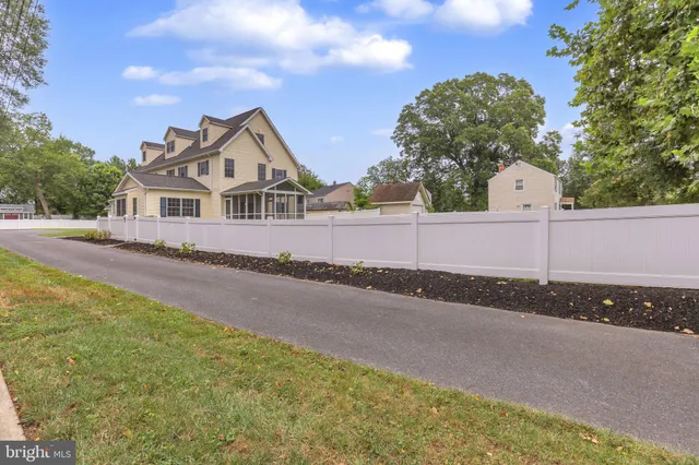 an aerial view of a house with a yard and lake view