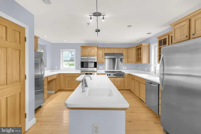 a view of kitchen with center island and stainless steel appliances