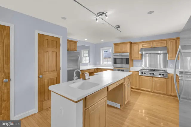 a view of a dining room with furniture a rug and wooden floor
