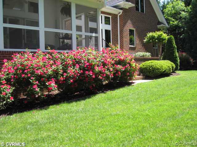 2300 Worchester Road Midlothian, VA 23113 - Photo 8 of 12 a garden with flowers and wooden fence