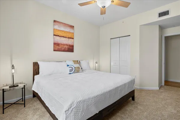 a bedroom with a bed and a chandelier