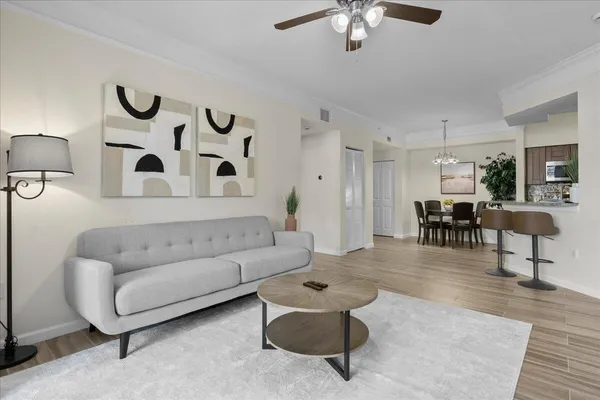 a living room with furniture and wooden floor