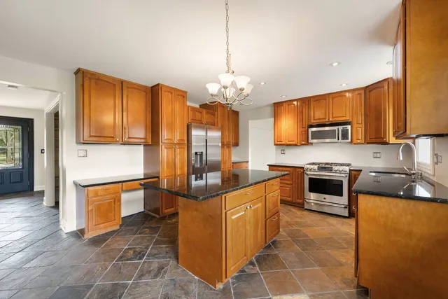 a kitchen with stainless steel appliances granite countertop a sink and cabinets