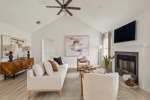 a living room with furniture and a fireplace