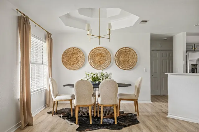 a dining room with furniture and a clock