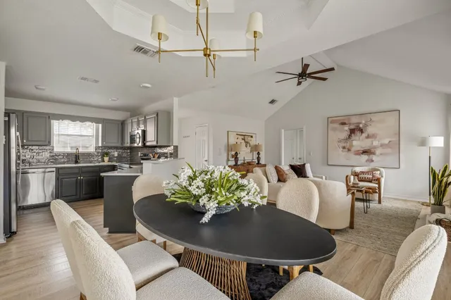 a living room with furniture kitchen view and a dining table