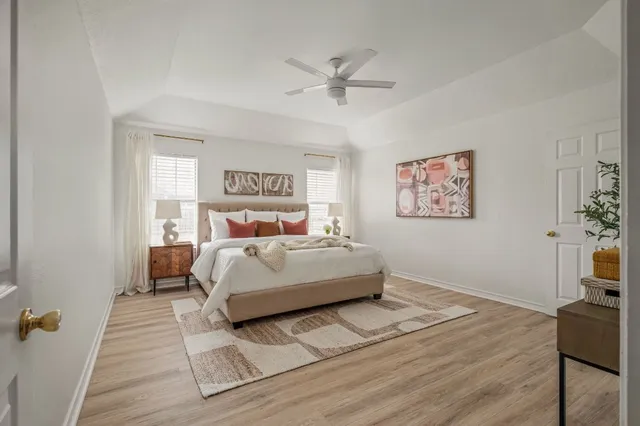 a bedroom with a bed and a chandelier