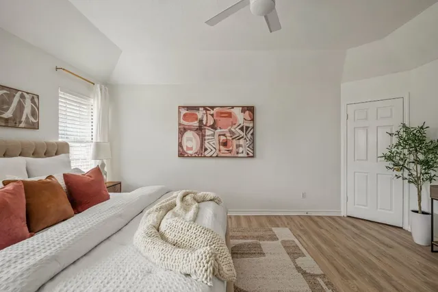 a bedroom with furniture and a potted plant