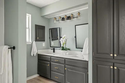 a bathroom with a double vanity sink and mirror