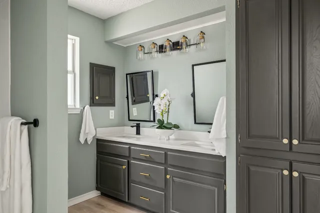 a bathroom with a double vanity sink and mirror