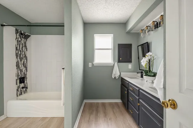 a bathroom with a bathtub a sink and a mirror