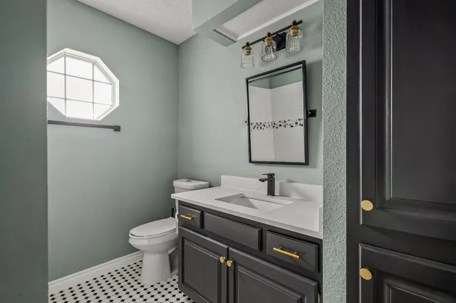 a bathroom with a sink a toilet and mirror