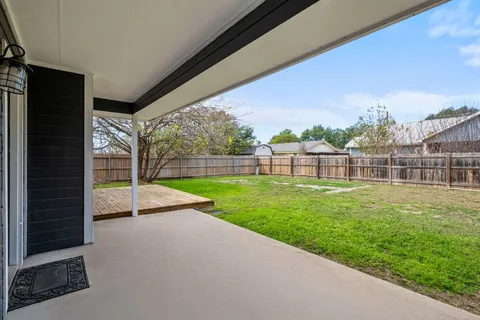 a view of outdoor space with deck and yard