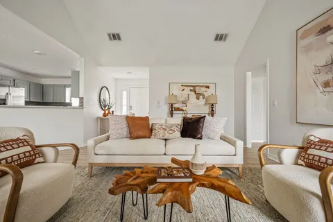 a living room with furniture a couch and wooden floor