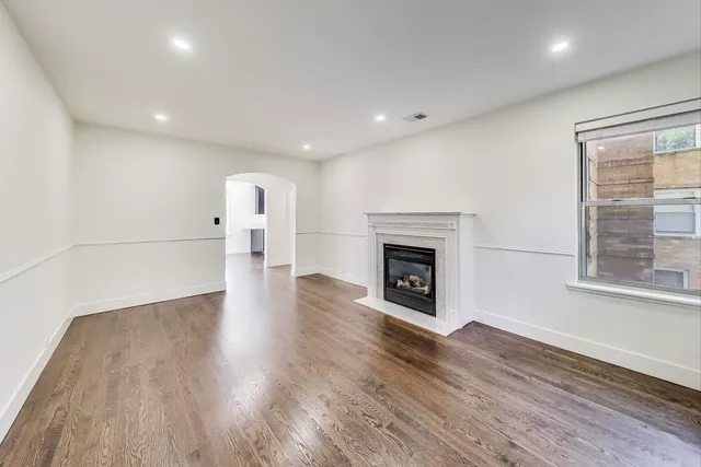 a view of a room with wooden floor