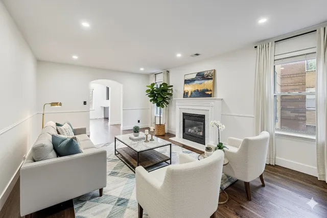a living room with furniture a fireplace and a window