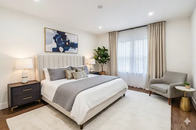 a bedroom with a bed and a painting on the wall