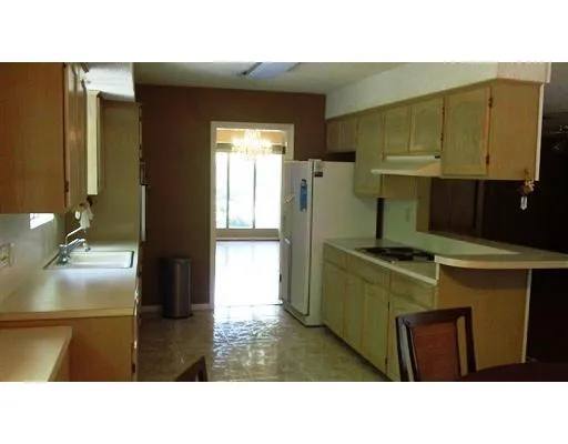a kitchen with a refrigerator a sink and a stove
