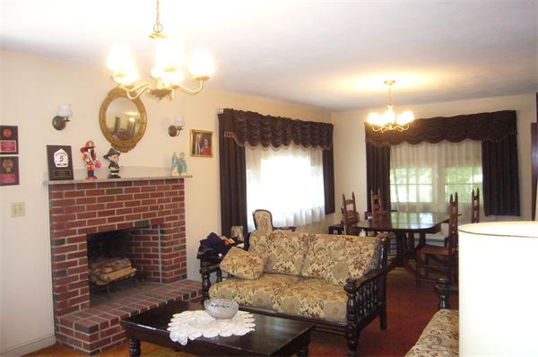 1 Pine Point Road Lynn, MA 01904 - Photo 2 of 15 a living room with furniture a large window and a fireplace