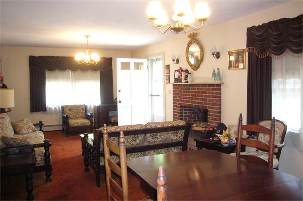 1 Pine Point Road Lynn, MA 01904 - Photo 3 of 15 a living room with furniture a fireplace and a chandelier