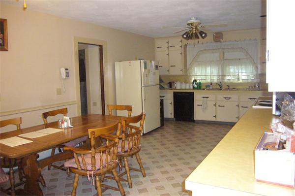 1 Pine Point Road Lynn, MA 01904 - Photo 6 of 15 a kitchen with stainless steel appliances kitchen island granite countertop a table chairs and a refrigerator