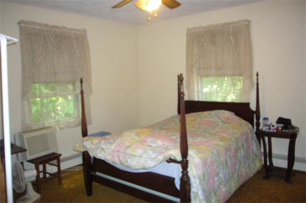 1 Pine Point Road Lynn, MA 01904 - Photo 7 of 15 a bed sitting in a bedroom next to a window