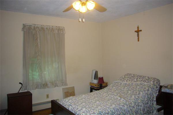 1 Pine Point Road Lynn, MA 01904 - Photo 9 of 15 a bedroom with a bed and a chandelier