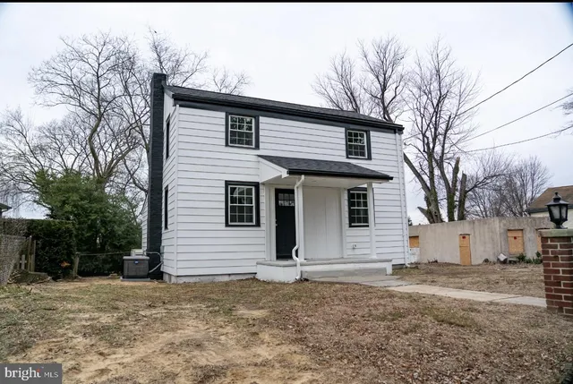 a view of a white house with a large space