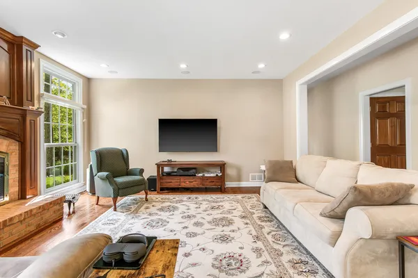 a living room with furniture and view of kitchen