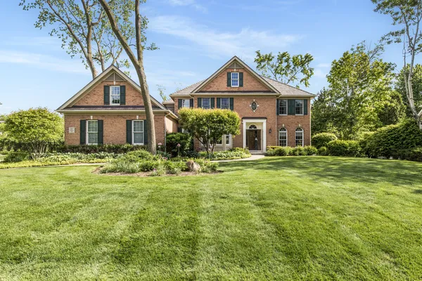 a front view of a house with a yard