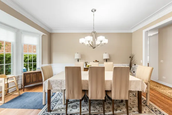a view of a dining room with furniture wooden floor and chandelier