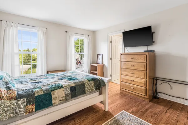 a bedroom with a bed and a television