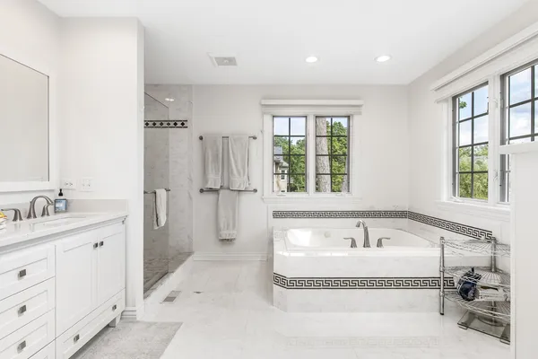 a bathroom with a double vanity sink mirror and shower